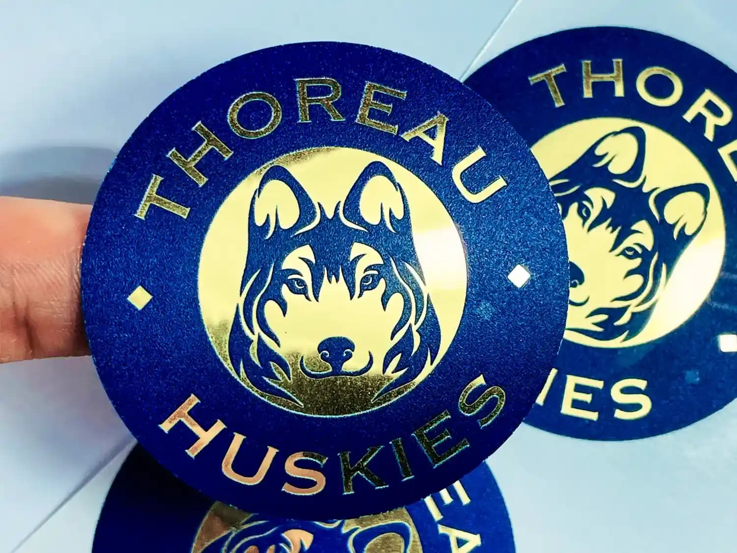 Gold foil stickers with a reflective metallic finish for upscale product labeling